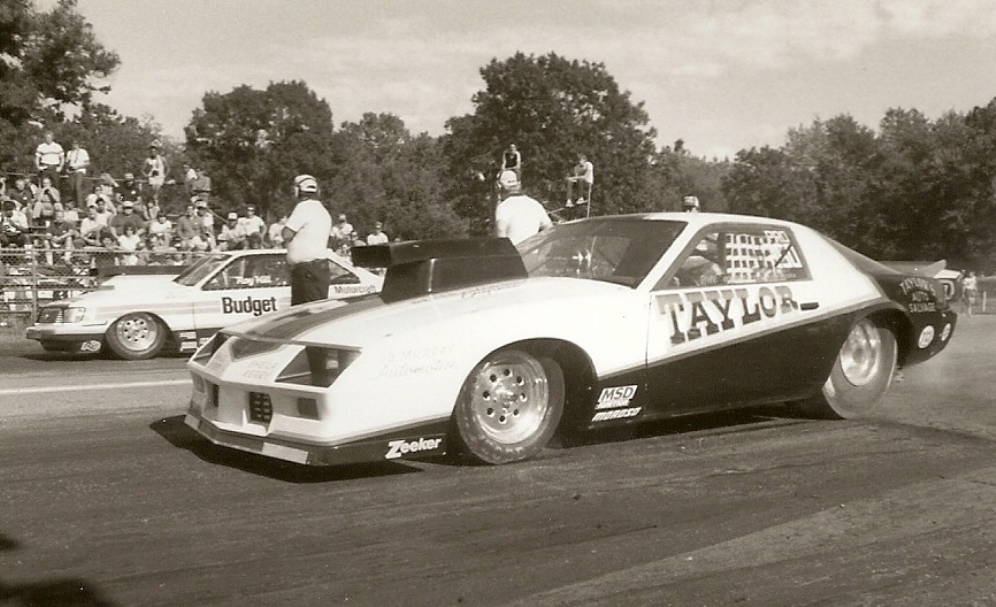 Bill Kuhlmann in John Taylors camaro vs Roy Hills “Budget” Merc at Martin, Pop Hotrod…