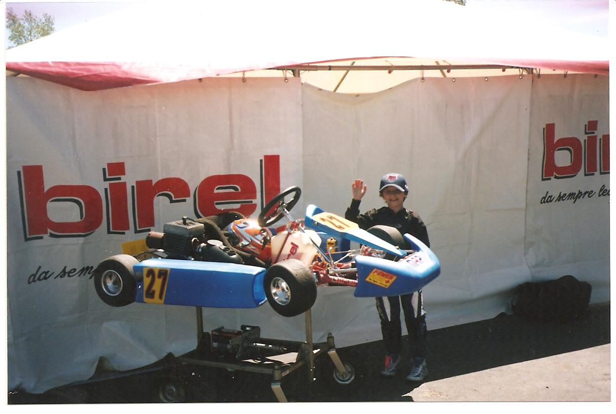 Brendan standing by kart